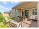 Cozy covered patio features ample seating, a dining area, and sliding doors that creates the perfect relaxation spot at 10160 Tree Blossom Ave, Las Vegas, NV 89166