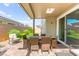 Charming covered patio offers an inviting outdoor dining space and comfortable seating area at 10160 Tree Blossom Ave, Las Vegas, NV 89166