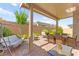 Relaxing covered patio with comfortable seating, swing, and dining area, perfect for enjoying the outdoors at 10160 Tree Blossom Ave, Las Vegas, NV 89166