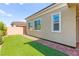 Well-maintained backyard with lush artificial turf, brick pathway, and privacy, a perfect outdoor oasis at 10160 Tree Blossom Ave, Las Vegas, NV 89166