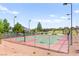 Outdoor community basketball court with fencing and lighting at 10160 Tree Blossom Ave, Las Vegas, NV 89166