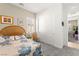 Bright bedroom features neutral walls, a woven headboard, and carpet flooring at 10160 Tree Blossom Ave, Las Vegas, NV 89166