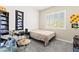 Bedroom featuring a single bed, bright window, and built-in shelving at 10160 Tree Blossom Ave, Las Vegas, NV 89166