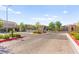 Community entrance featuring brick-paved street, landscaped median, and black iron gate at 10160 Tree Blossom Ave, Las Vegas, NV 89166
