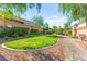 Landscaped community grounds featuring walking path, grassy area, and mature trees at 10160 Tree Blossom Ave, Las Vegas, NV 89166
