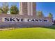 Stone community sign for Skye Canyon with well-manicured landscaping and vibrant green turf at 10160 Tree Blossom Ave, Las Vegas, NV 89166