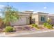 Charming home exterior features a brick driveway, stone accents, and well-manicured landscaping at 10160 Tree Blossom Ave, Las Vegas, NV 89166