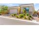 Stylish home exterior boasts a brick driveway, stone accents, and lush landscaping for curb appeal at 10160 Tree Blossom Ave, Las Vegas, NV 89166