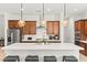 A modern kitchen features an island with bar stool seating and stainless steel appliances at 10160 Tree Blossom Ave, Las Vegas, NV 89166
