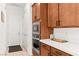 Kitchen with stainless steel appliances and white countertops next to entry to garage at 10160 Tree Blossom Ave, Las Vegas, NV 89166