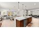 Bright open kitchen has a center island, wooden cabinets, and modern lighting at 10160 Tree Blossom Ave, Las Vegas, NV 89166