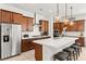Bright kitchen with stainless steel appliances, modern lighting, and center island with seating at 10160 Tree Blossom Ave, Las Vegas, NV 89166