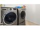 Modern laundry room features front load washer and dryer at 10160 Tree Blossom Ave, Las Vegas, NV 89166