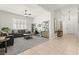 Bright living room with gray sofas, shutters, and built-in bookshelves at 10160 Tree Blossom Ave, Las Vegas, NV 89166