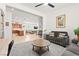 Open-concept living room and kitchen area with tile and carpet flooring at 10160 Tree Blossom Ave, Las Vegas, NV 89166