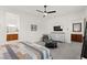 Bright main bedroom featuring a ceiling fan, TV and a charming sitting area with a gray accent chair at 10160 Tree Blossom Ave, Las Vegas, NV 89166