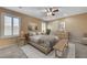 Cozy bedroom featuring neutral tones, complemented by ample natural light and views of the exterior landscape at 10343 Beallsville St, Las Vegas, NV 89141
