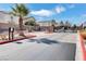 Gated community entrance with palm trees and well-maintained landscaping, offering enhanced privacy and security at 10343 Beallsville St, Las Vegas, NV 89141
