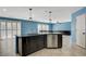 Open concept kitchen with sleek cabinets, stainless appliances and granite island at 10343 Beallsville St, Las Vegas, NV 89141