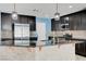 Modern kitchen with dark cabinetry, stainless steel appliances, and granite countertops at 10343 Beallsville St, Las Vegas, NV 89141