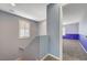 Bright staircase landing with natural light, a gray-blue accent wall, and carpeted stairs leading up and down at 10343 Beallsville St, Las Vegas, NV 89141