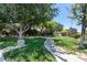 Beautiful community park featuring lush green grass, walking paths, and mature shade trees at 10352 Natural Springs Ave, Las Vegas, NV 89129