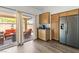 Bright kitchen features wooden cabinets, stainless steel refrigerator, and sliding glass doors to an outdoor living space at 10352 Natural Springs Ave, Las Vegas, NV 89129
