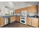 Functional kitchen featuring light wood cabinets, modern appliances, and wood flooring at 10352 Natural Springs Ave, Las Vegas, NV 89129