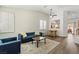 Bright living room with views to the kitchen, with plantation shutters, and wood flooring at 10352 Natural Springs Ave, Las Vegas, NV 89129