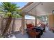 Relaxing covered patio with ample seating, string lights, and a charming desert landscaped yard at 10352 Natural Springs Ave, Las Vegas, NV 89129