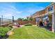 A spacious yard with desert landscaping, patio, benches, and an outdoor kitchen at 1228 Swanbrooke Dr, Las Vegas, NV 89144