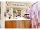 This bathroom features a wood vanity and shower with purple patterned curtains at 1228 Swanbrooke Dr, Las Vegas, NV 89144