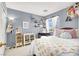 Cozy bedroom featuring charming decor, neutral carpet, and lots of natural light at 1228 Swanbrooke Dr, Las Vegas, NV 89144