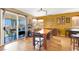 Cozy dining area with a wooden table, seating for six, and sliding glass doors at 1228 Swanbrooke Dr, Las Vegas, NV 89144