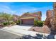 Charming two-story home with a well-maintained front yard and a spacious two-car garage at 1228 Swanbrooke Dr, Las Vegas, NV 89144