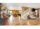 Open-concept living area featuring hardwood floors, a staircase, and comfortable seating arrangements at 1228 Swanbrooke Dr, Las Vegas, NV 89144