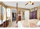 This main bedroom features a four-post bed, carpeting, and an open closet at 1228 Swanbrooke Dr, Las Vegas, NV 89144