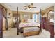 This main bedroom features a four-post bed, ceiling fan, and two dressers at 1228 Swanbrooke Dr, Las Vegas, NV 89144