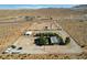 Expansive property featuring a single-story home, large yard, and multiple outbuildings with desert views at 12992 State Hwy 160, Las Vegas, NV 89161