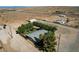 Aerial shot showcases the property, mature trees, and fully fenced backyard oasis at 12992 State Hwy 160, Las Vegas, NV 89161