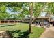 A large backyard with a tree, patio set, and outdoor fireplace at 12992 State Hwy 160, Las Vegas, NV 89161