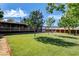 Expansive backyard featuring a lush green lawn, mature trees, and a patio seating area for outdoor relaxation at 12992 State Hwy 160, Las Vegas, NV 89161