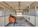 Inside the barn showcasing multiple horse stalls, durable brick flooring, and adequate lighting at 12992 State Hwy 160, Las Vegas, NV 89161