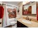 Bathroom featuring a granite vanity, tiled shower, and framed mirror at 12992 State Hwy 160, Las Vegas, NV 89161