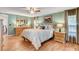 Cozy bedroom offers a ceiling fan, hardwood floors, and natural light at 12992 State Hwy 160, Las Vegas, NV 89161
