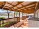 Inviting covered patio with wooden deck, railing, and serene views of the surrounding desert landscape at 12992 State Hwy 160, Las Vegas, NV 89161