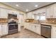 Updated kitchen features custom cabinets, granite counters, and stainless appliances at 12992 State Hwy 160, Las Vegas, NV 89161