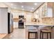 Modern kitchen with white cabinets, stainless steel appliances, and breakfast bar seating at 12992 State Hwy 160, Las Vegas, NV 89161