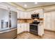 The bright kitchen has custom cabinets, granite counters, and stainless appliances at 12992 State Hwy 160, Las Vegas, NV 89161