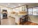 Updated kitchen features custom cabinets, granite counters, stainless appliances, and breakfast bar with seating at 12992 State Hwy 160, Las Vegas, NV 89161